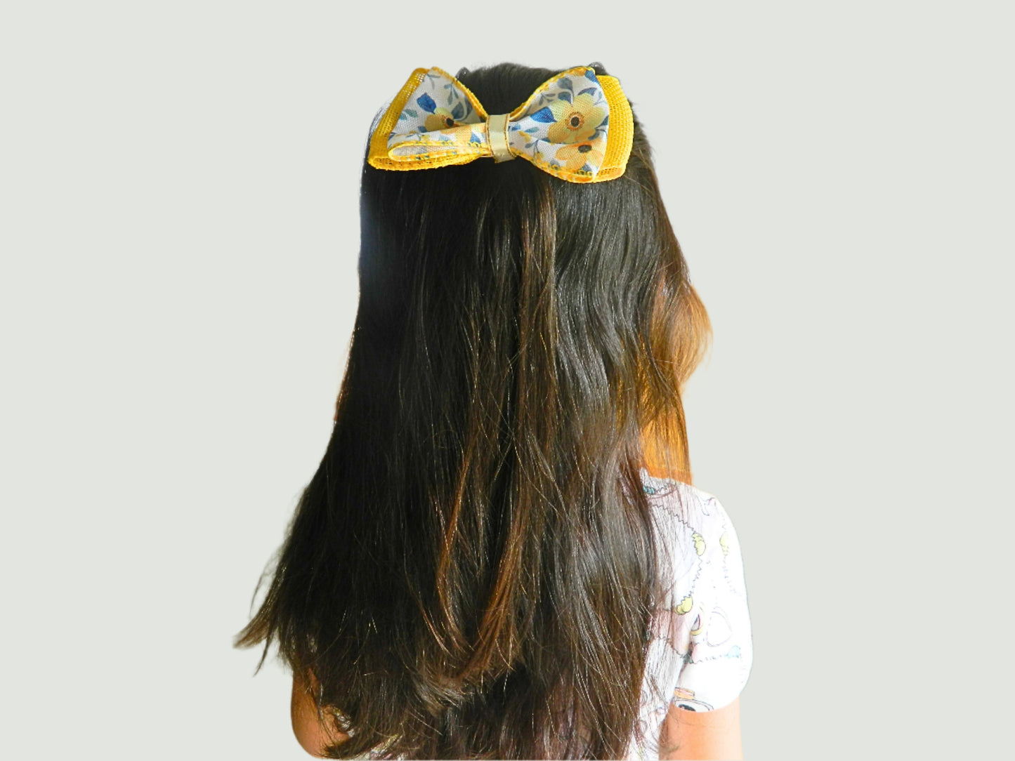 yellow flowers bow on a girl